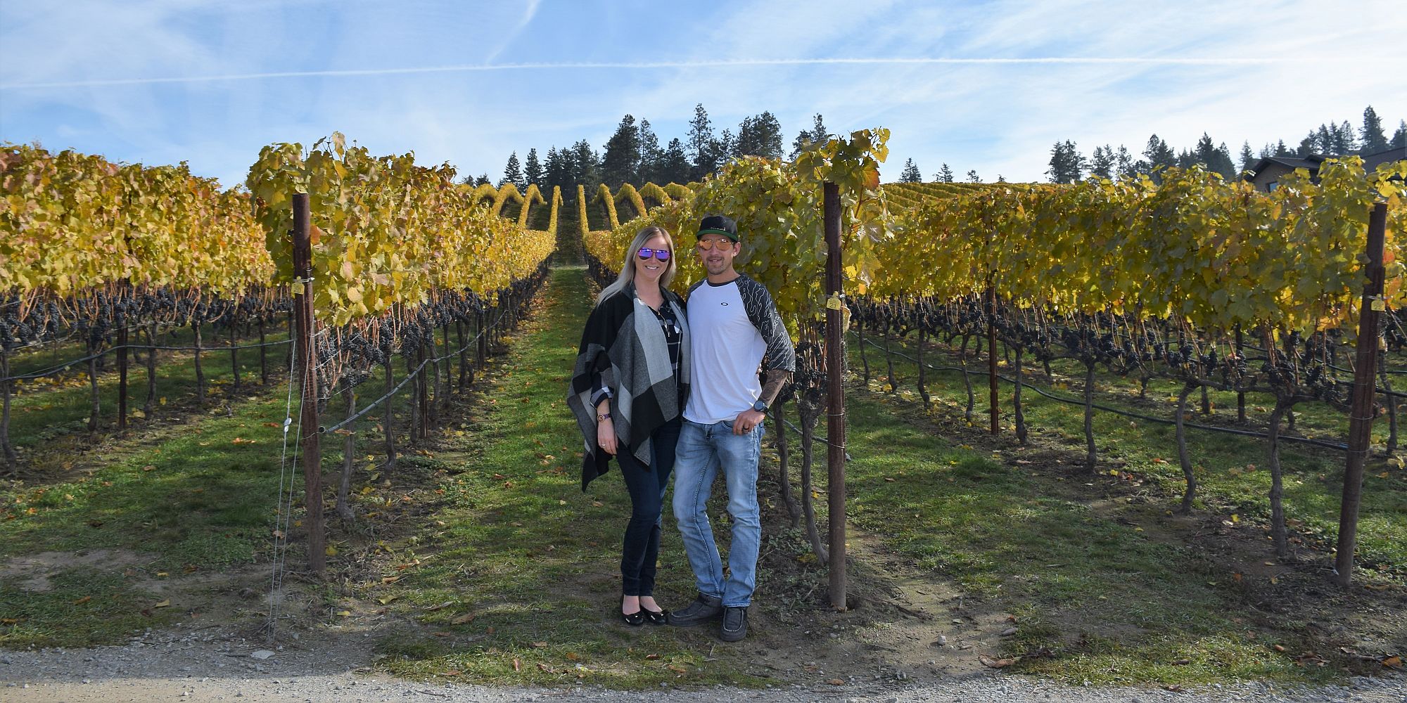 A Couple Standing Next To Ripe Pinot Noir Grape Clusters In The Ex Nihilo Vineyard
