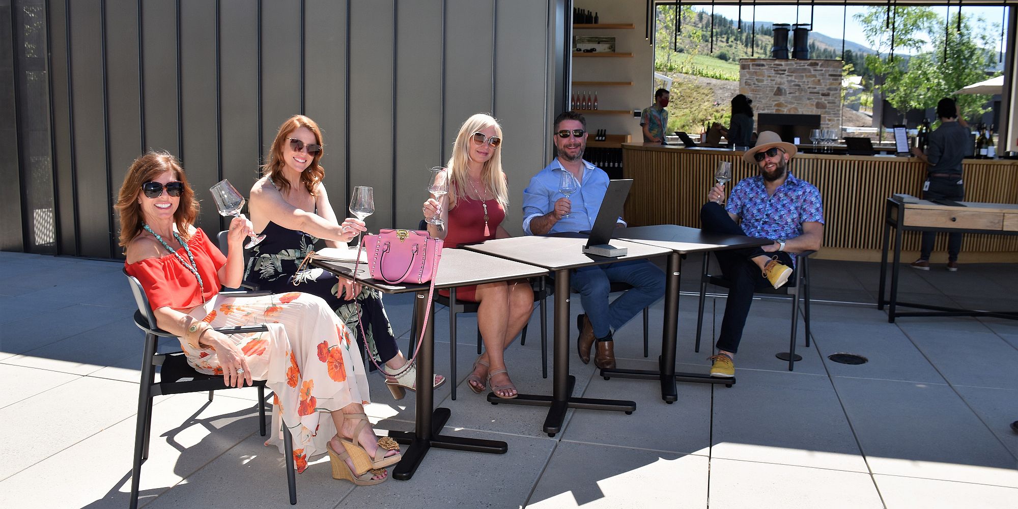 Five Friends Enjoying A Seated Patio Wine Tasting At Cedar Creek Estate Winery
