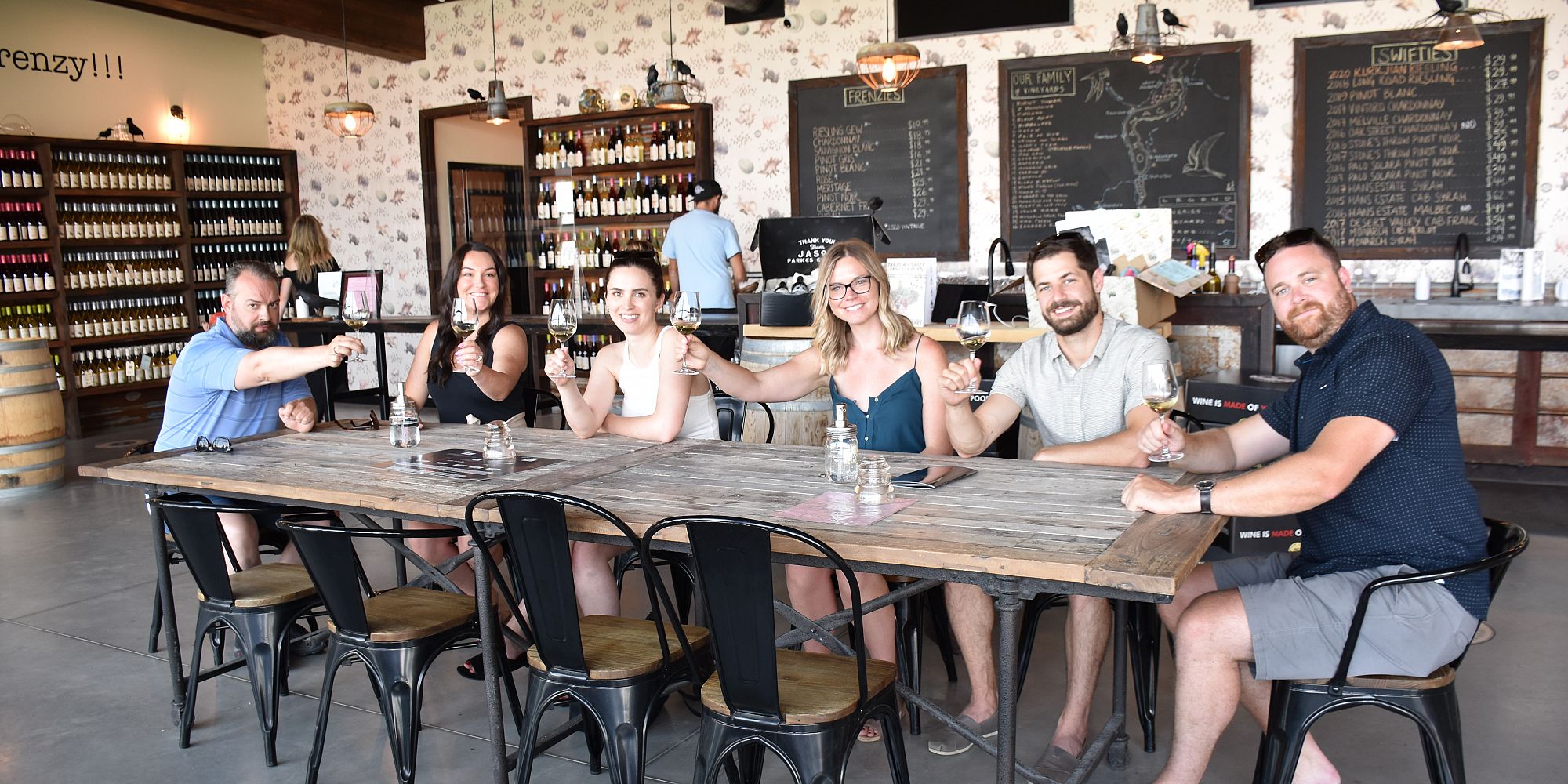 Six Friends Enjoying A Seated Wine Tasting In Black Swift Vineyards Tasting Room