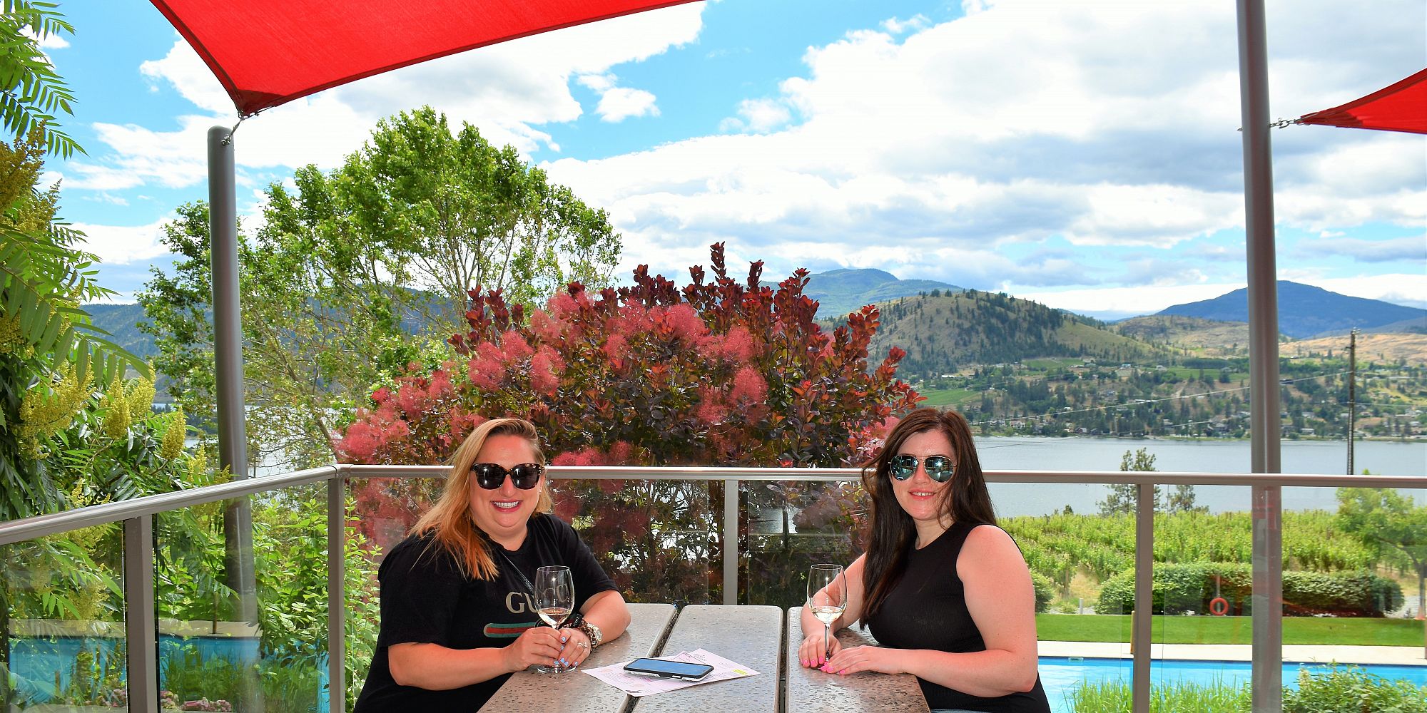 Two Sisters Enjoying A Seated Patio Wine Tasting At Blasted Church Winery
