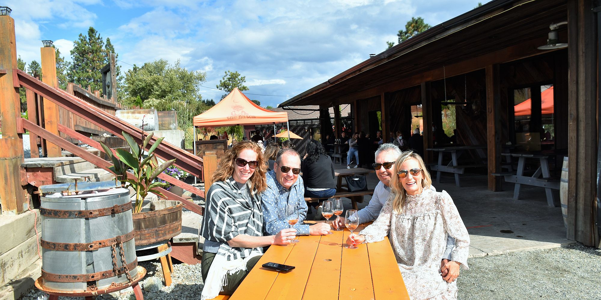 Two Couples Enjoying A Seated Outdoor Wine Tasting At The Hatch Winery