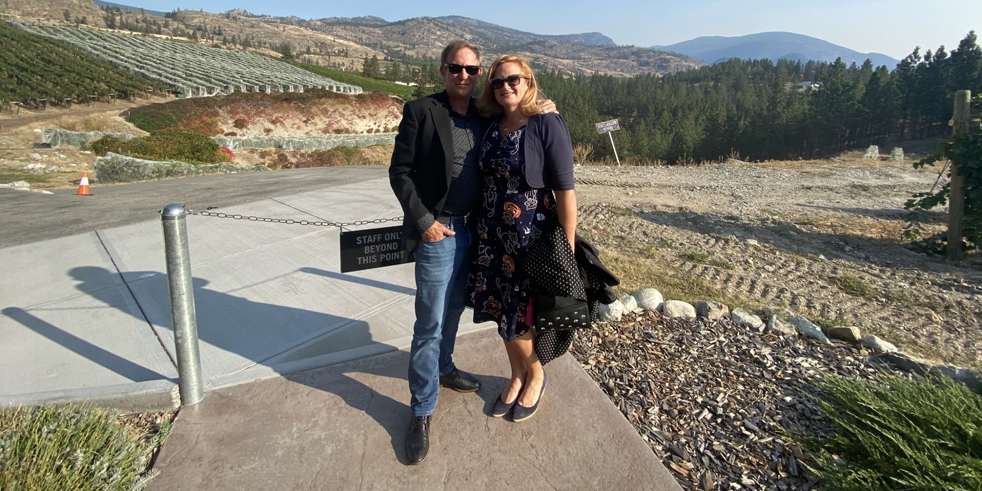 Couple Standing In Front Of The Vineyards At Stags Hallow Winery