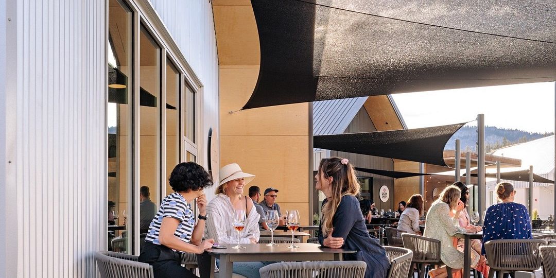 Three Ladies Enjoying A Seated Patio Wine Tasting At The District Wine Village