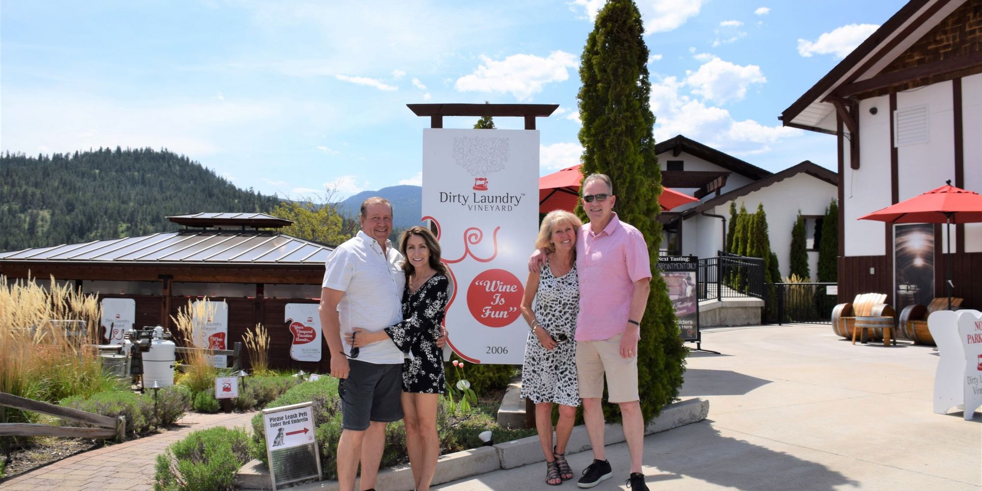 Two Couples In Front Of The Dirty Laundry Vineyards Sign