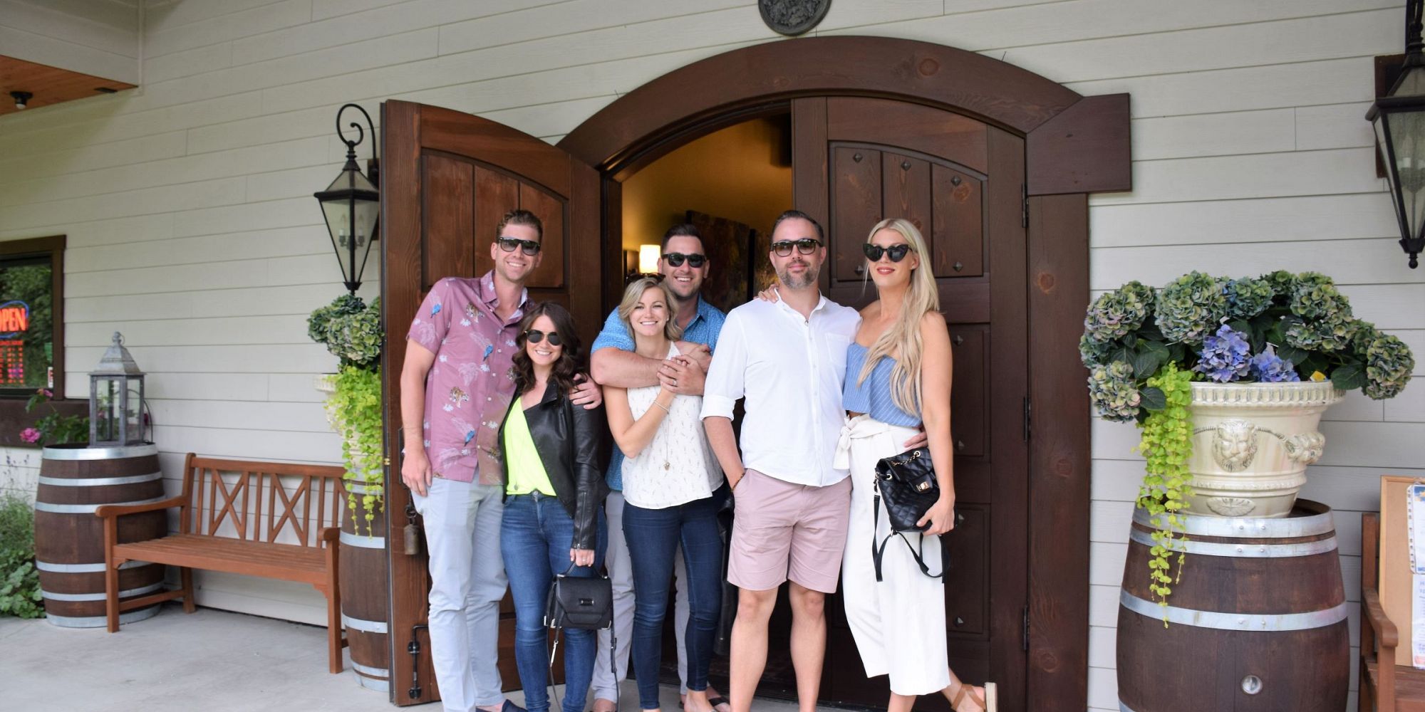 Three Couples Standing At The Entrance Of Ancient Hills Estate Winery