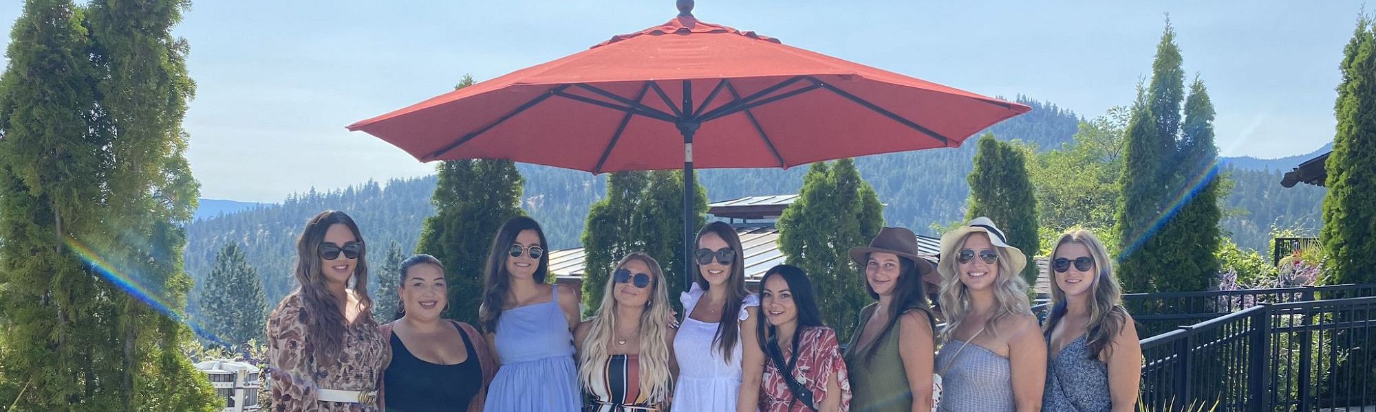 Stagette Group on the patio under large red umbrella at Dirty Laundry Vineyard