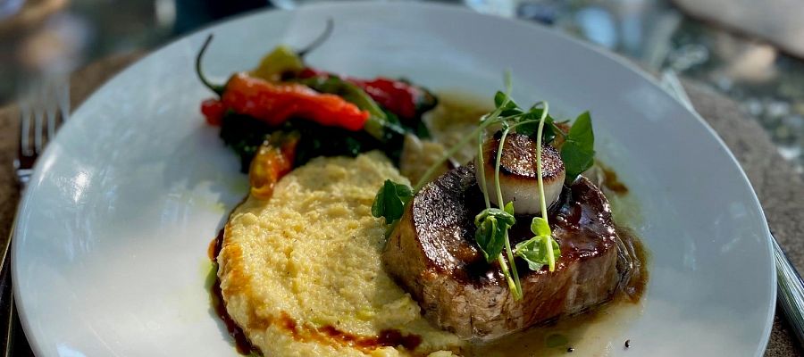 Delicious Pork Shoulder, Scallop, Peppers and Mashed Veggie plate on the Patio at Old Vines Resturant